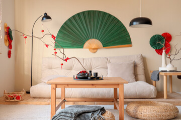 Interior of living room with sofa, tables and decor for Chinese New Year celebration