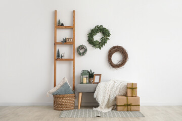 Interior of living room with Christmas wreaths, bench and ladder