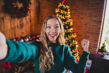 Photo of attractive teen girl selfie photo winning dressed green christmas outfit cozy day light home party decoration interior living room