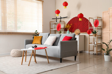 Interior of living room with sofa, tables and decor for Japanese New Year celebration