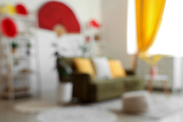 Blurred view of light living room with sofa, shelf units and decor for Japanese New Year celebration