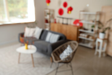 Blurred view of living room with sofa, shelf units and decor for Japanese New Year celebration