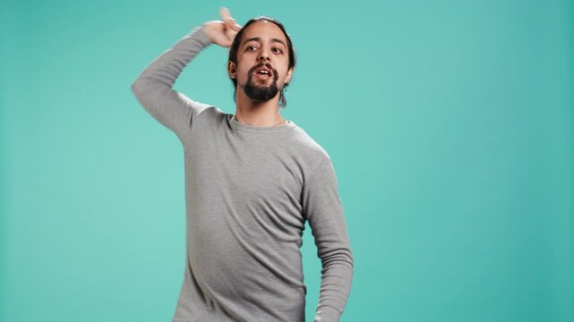 Portrait of menacing man threating to hit enemy during fight. Wrathful Arab person full of rage intimidating mate, holding weapon, isolated over studio background, camera B