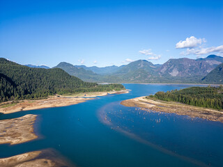 Obraz premium Aerial View of Stave Lake Surrounded by Lush Forests and Mountain Range in Mission, BC, Canada