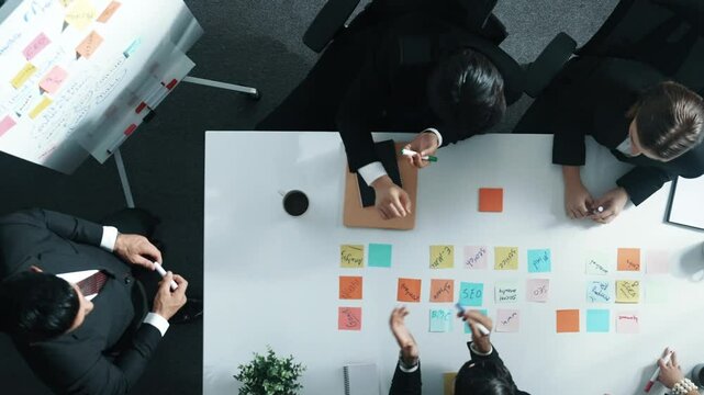 Top down aerial view of businessman report sales to project manager while startup team clapping hands to celebrate increased profit at meeting room. Group of manager finding a solution. Directorate.