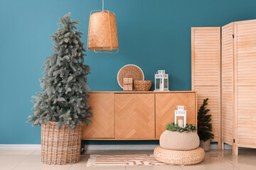 Interior of living room with Christmas trees, commode and poufs