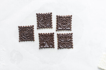 top view of stamped gingerbread cookie dough, Overhead view of cut out molasses cookie dough on a marble countertop, process of making christmas cookies