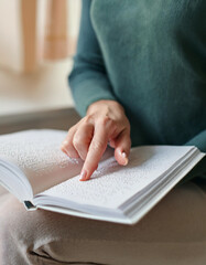 Hand of a blind person reading some braille text touching the relief. Empty copy space for Editor's content.
