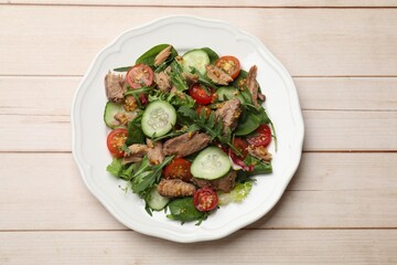 Delicious fresh tuna salad on white wooden table, top view