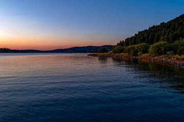 The rocky shore of Georgetown Lake at dusk in Montana, USA