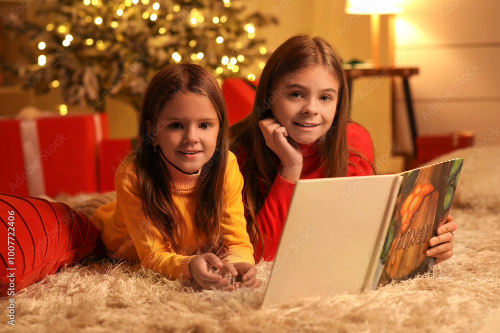 Canvas Prints Cute happy little girls with book reading Christmas story at night