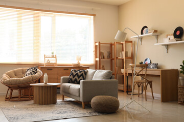 Interior of stylish living room with sofa, armchair and vinyl disks