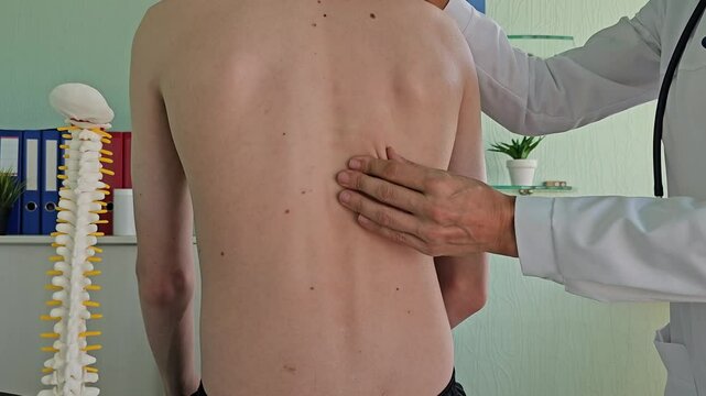 Medical examination of the patient back with emphasis on spinal alignment and health assessment. The problem of back pain