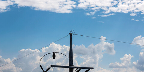 Electric poles with a beautiful cloudy sky in the background