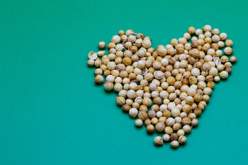 Pile of dried coriander seeds. A Close-up background texture of dried coriander seeds