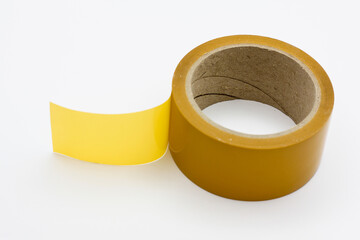 Roll of yellow duct tape on a white background