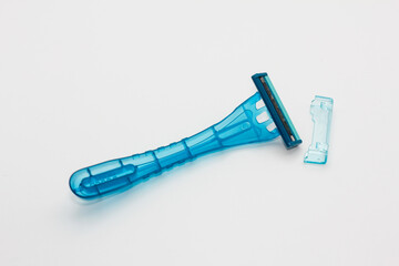 Blue disposable razor blade isolated on white background. Single use razor blade. Disposable shaving razor.