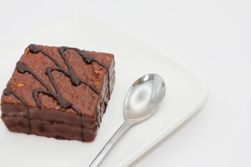 delicious chocolate cake on a white plate. square chocolate cake