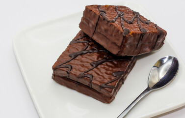 delicious chocolate cake on a white plate. square chocolate cake