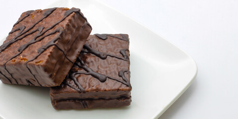 delicious chocolate cake on a white plate. square chocolate cake