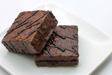 delicious chocolate cake on a white plate. square chocolate cake
