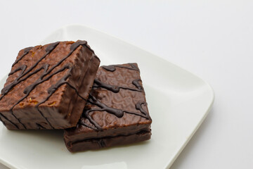 delicious chocolate cake on a white plate. square chocolate cake
