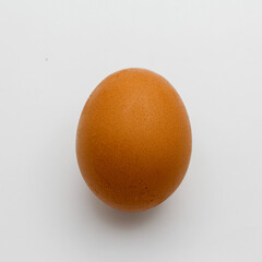 Single brown chicken egg isolated on white background
