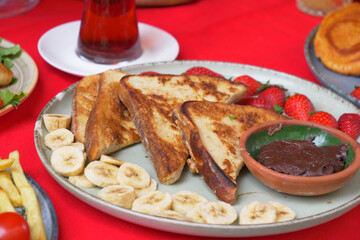 Enjoy French Toast with Nutella, fresh berries, and bananas for a delightful meal