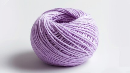 A purple ball of yarn sits on a white background