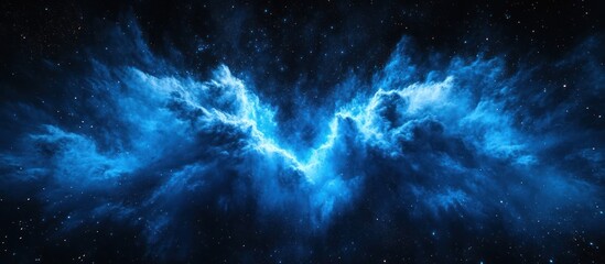 Obraz premium A vibrant blue nebula with a bright center glows against a dark starry background.