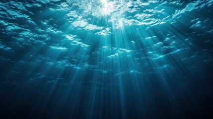 Underwater scene with sunlight rays illuminating the ocean depths.