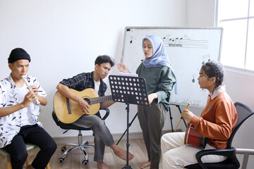 Group Of Diversity Asian Students Singing And Playing Musical Instruments Together