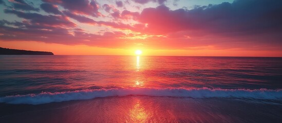 Stunning Ocean Sunset with Vibrant Colors and Dramatic Clouds Reflecting on Calm Water at Dusk