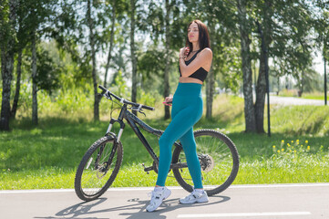 Caucasian woman riding a bike in a park. 