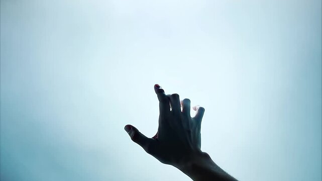 A hand reaching out through mist or fog, conveying a sense of longing or searching.