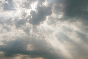 Obraz premium overcast sky with dark dramatic clouds and sun rays after thunderstorm.