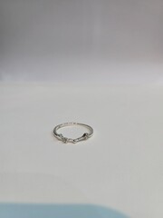 silver or white gold ring in star shape design minimal ring for teenager. ring on white paper for jewelry marketing