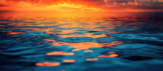 Abstract background of orange and blue hues reflecting on water surface.