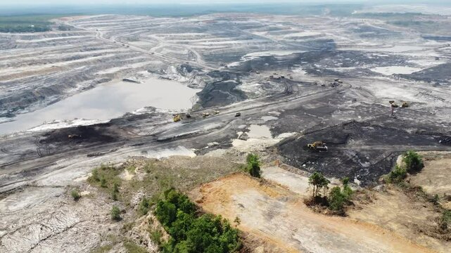 Aerial view panorama of open pit coal mining, dumper, extractive industry excavation, very large mine. Big Yellow Mining Truck