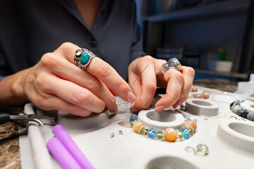 Craft jewelery making with professional tools. A handmade jeweler process, manufacture of jewellery