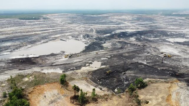 Aerial view panorama of open pit coal mining, dumper, extractive industry excavation, very large mine. Big Yellow Mining Truck