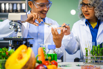 A reliable middle-aged Asian male researcher collaborates with experienced gray-haired elderly...