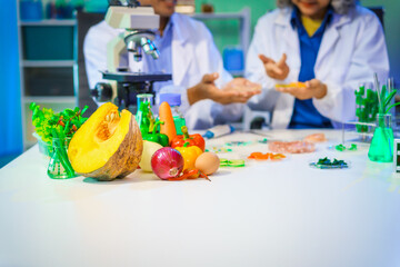 A reliable middle-aged Asian male researcher collaborates with experienced gray-haired elderly Asian female nutritionist in laboratory, food ingredients, extracts, their impact on nutrition health.