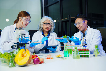 A reliable middle-aged Asian male researcher collaborates with experienced gray-haired elderly Asian female nutritionist in laboratory, food ingredients, extracts, their impact on nutrition health.