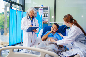 A middle-aged man lies bedridden on hospital bed, closely monitored by an old Asian woman doctor and young nurse. They assess his symptoms, including heart and lung conditions, offer advice.