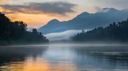 The tranquil beauty of the Khwae Noi River at dawn, with mist rising from the water.