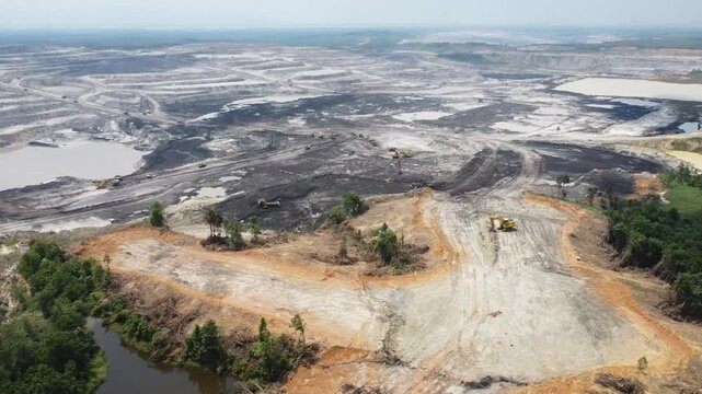 Aerial view panorama of open pit coal mining, dumper, extractive industry excavation, very large mine. Big Yellow Mining Truck