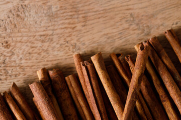 Dried Cinnamomum cassia on wooden table.