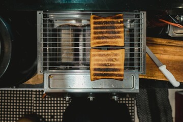 Two scorched loaves of toasted bread on the modern gas roaster