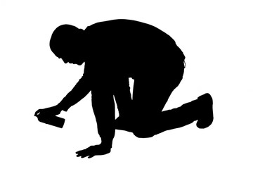  silhouette of a man painting on the floor with spray